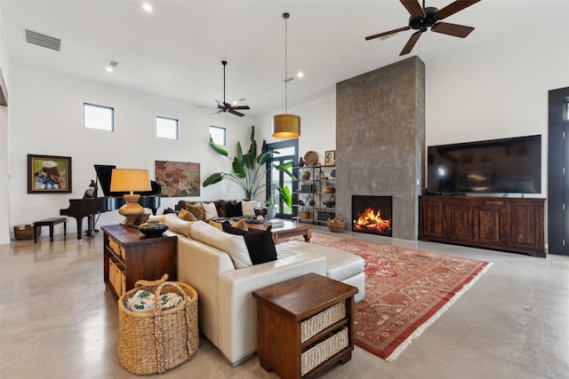 living area featuring visible vents, a large fireplace, ceiling fan, recessed lighting, and concrete flooring
