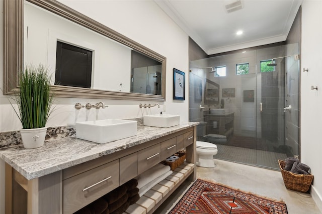 bathroom featuring toilet, a shower stall, and a sink