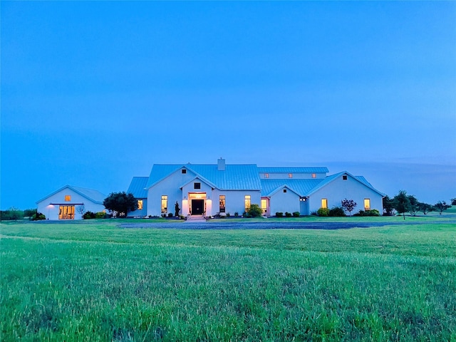 view of front of home featuring metal roof, a standing seam roof, and a chimney