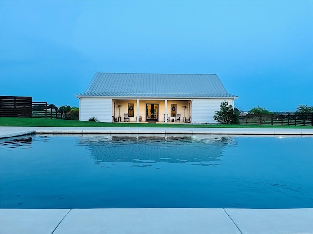 view of swimming pool featuring fence