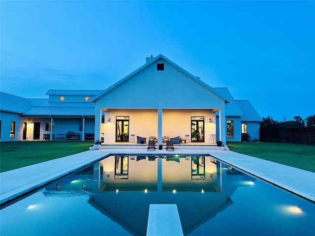 pool featuring a yard and a patio area