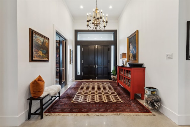 foyer featuring recessed lighting, a notable chandelier, baseboards, finished concrete floors, and ornamental molding