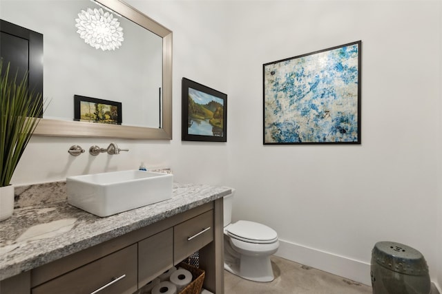 bathroom featuring toilet and vanity