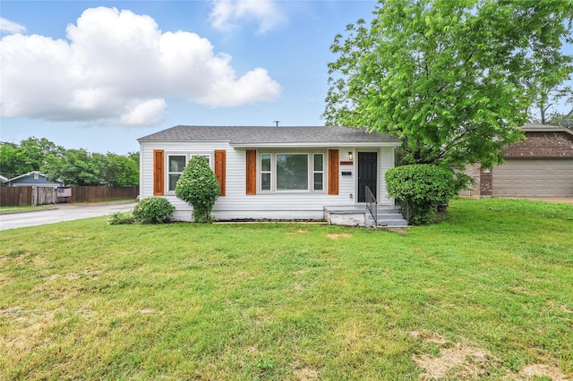 single story home with fence and a front lawn