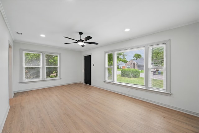 unfurnished room featuring crown molding, light wood finished floors, a ceiling fan, and visible vents