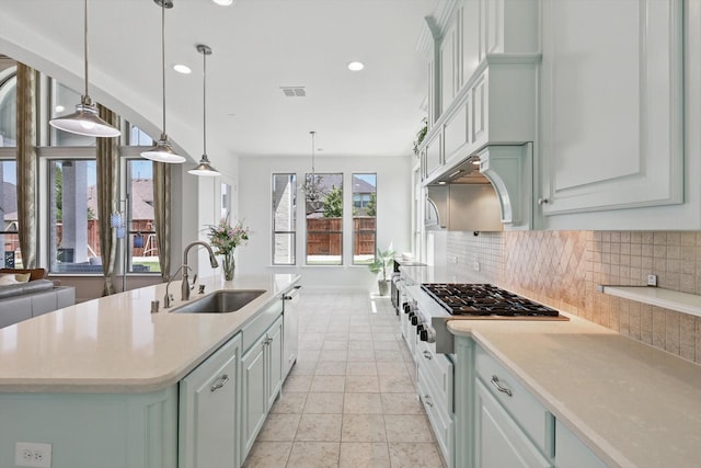 741 Almeda Ln, Prosper, TX 75078 - kitchen with a sink, appliances with stainless steel finishes, decorative backsplash, light countertops, and an island with sink