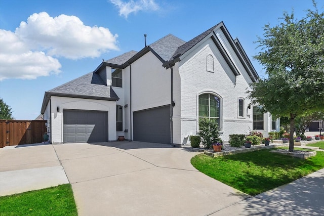 741 Almeda Ln, Prosper, TX 75078 - view of front facade with concrete driveway, a garage, brick siding, and a shingled roof