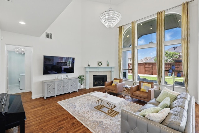 741 Almeda Ln, Prosper, TX 75078 - living area featuring a chandelier, high vaulted ceiling, wood finished floors, baseboards, and a fireplace