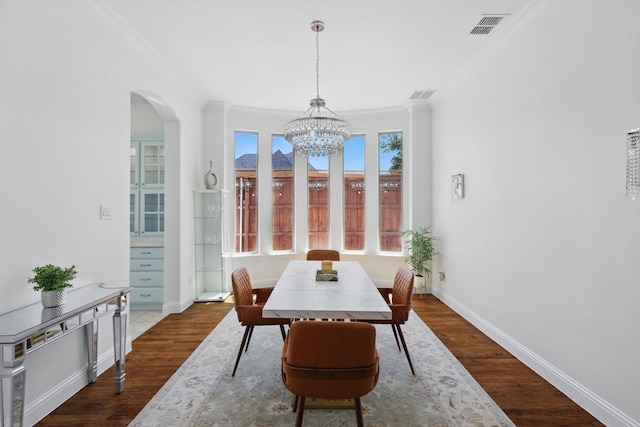 741 Almeda Ln, Prosper, TX 75078 - dining room featuring crown molding, a chandelier, dark wood-style flooring, arched walkways, and baseboards