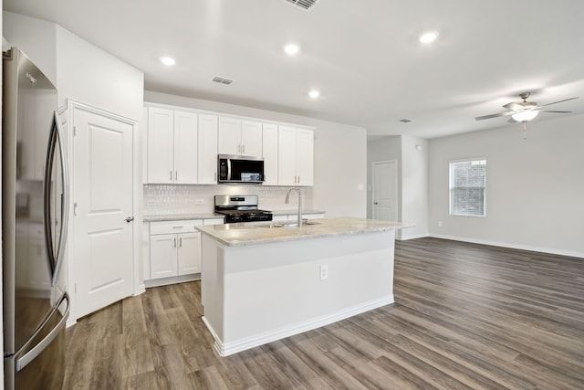 419 Bertney Dr, Princeton, TX 75071 - kitchen featuring dark wood-style flooring, a sink, tasteful backsplash, visible vents, and appliances with stainless steel finishes