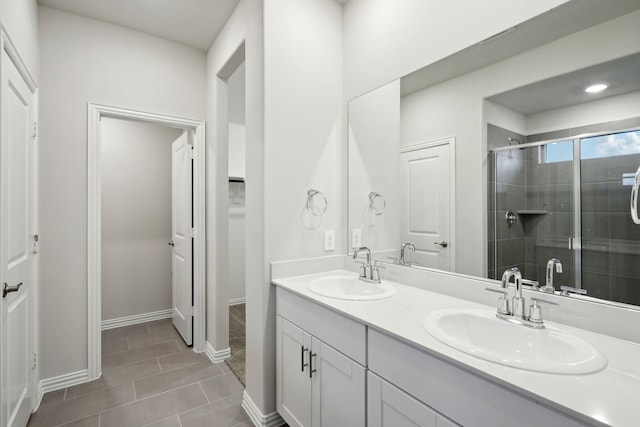 419 Bertney Dr, Princeton, TX 75071 - bathroom with a stall shower, tile patterned flooring, double vanity, and a sink