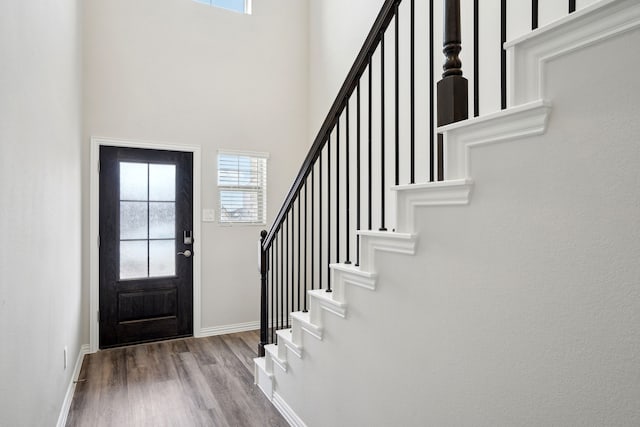 419 Bertney Dr, Princeton, TX 75071 - foyer with baseboards, stairway, wood finished floors, and a towering ceiling