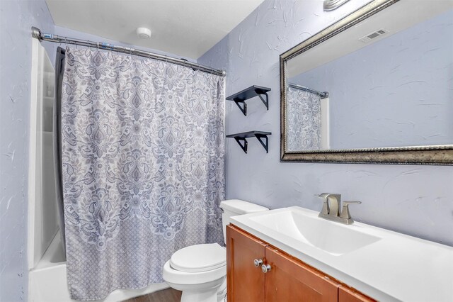 bathroom featuring toilet, visible vents, shower / bathtub combination with curtain, and vanity