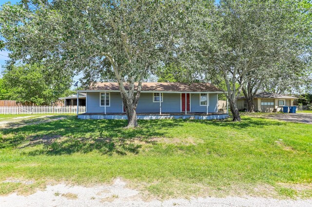 single story home with fence, a front yard, and a porch