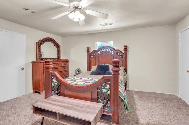 carpeted bedroom with visible vents and a ceiling fan