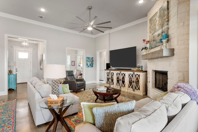 living area with crown molding, ceiling fan, visible vents, recessed lighting, and a fireplace