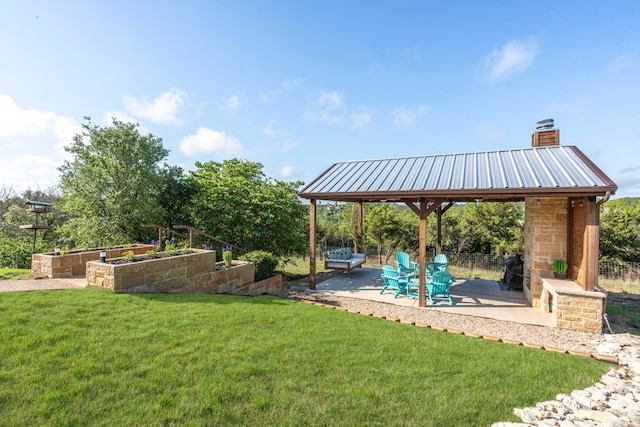 view of yard featuring fence, a gazebo, a patio area, and a garden