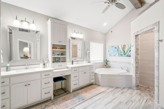 bathroom featuring two vanities, ceiling fan, a garden tub, and a sink