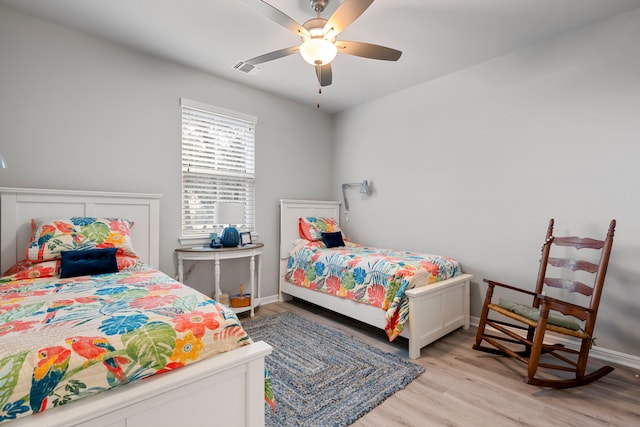 bedroom with visible vents, ceiling fan, light wood-style flooring, and baseboards
