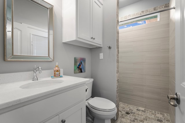 full bath with toilet, vanity, and a shower stall