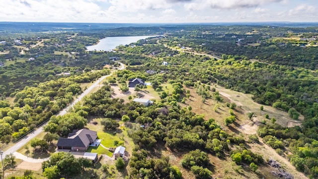 drone / aerial view featuring a water view and a forest view