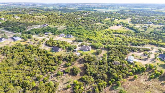 birds eye view of property with a view of trees