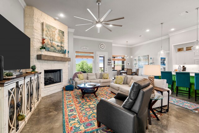 living area featuring concrete flooring, ceiling fan, a stone fireplace, visible vents, and ornamental molding