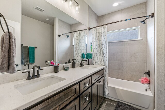 bathroom with visible vents, shower / bath combo, tile patterned flooring, and a sink
