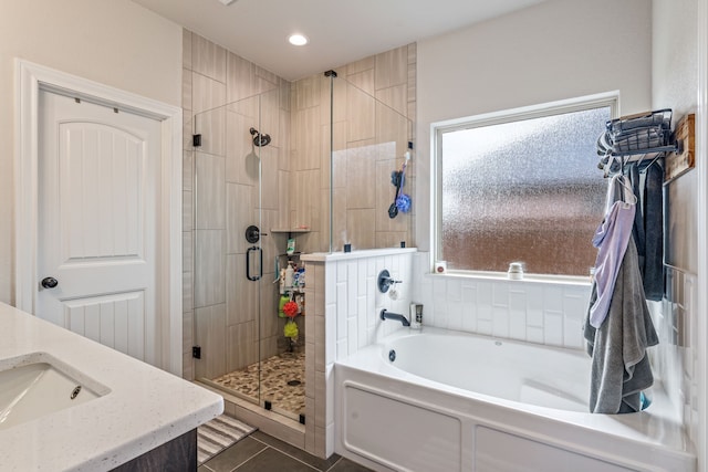 full bathroom featuring a shower stall, a sink, recessed lighting, a bath, and tile patterned floors