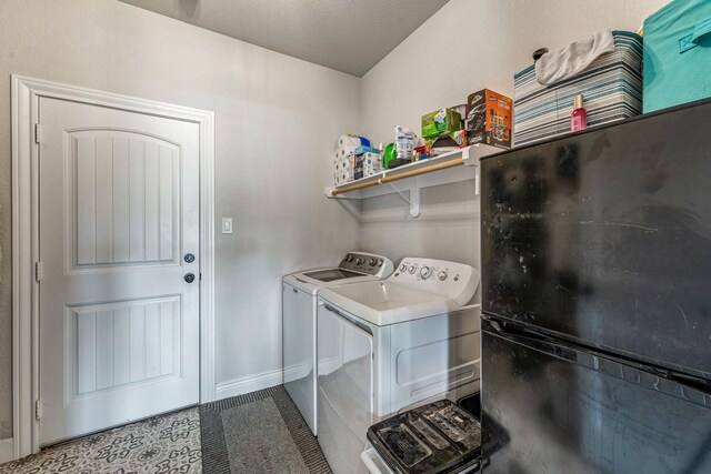 laundry room with washing machine and dryer, laundry area, and baseboards