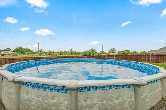 view of swimming pool with a fenced in pool and a fenced backyard