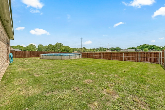 view of yard with a fenced in pool and a fenced backyard