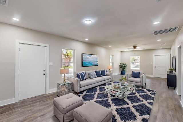 1500 W Collin, Corsicana, TX 75110 - living area featuring plenty of natural light, wood finished floors, baseboards, and recessed lighting