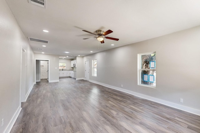 1500 W Collin, Corsicana, TX 75110 - unfurnished living room featuring a ceiling fan, dark wood-type flooring, recessed lighting, and baseboards