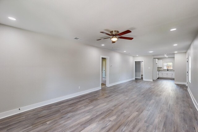 1500 W Collin, Corsicana, TX 75110 - unfurnished living room with a ceiling fan, dark wood-style flooring, recessed lighting, and baseboards