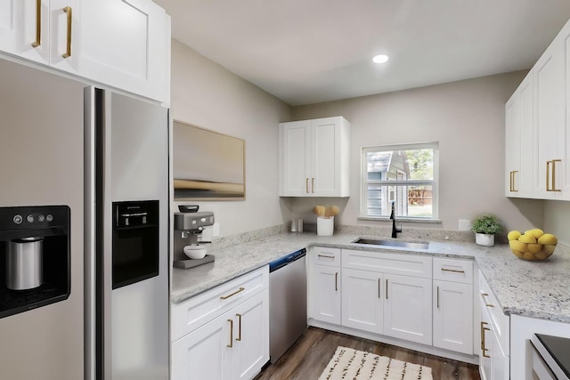 1500 W Collin, Corsicana, TX 75110 - kitchen featuring stainless steel appliances, a sink, white cabinets, dark wood-type flooring, and light stone countertops