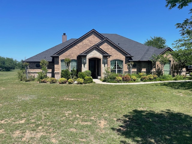 125 Rattling Antler Ct, Azle, TX 76020 - view of front of home with brick siding, a shingled roof, a front yard, and a chimney
