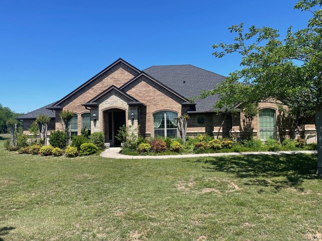 125 Rattling Antler Ct, Azle, TX 76020 - view of front of home featuring a shingled roof, a front lawn, and brick siding