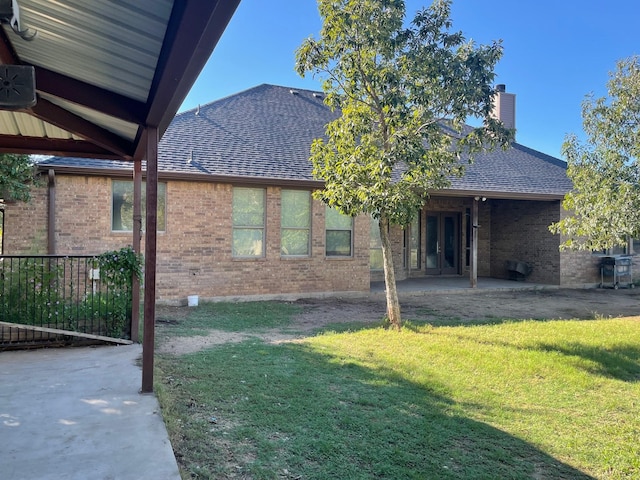 125 Rattling Antler Ct, Azle, TX 76020 - back of house featuring roof with shingles, a chimney, a lawn, and brick siding