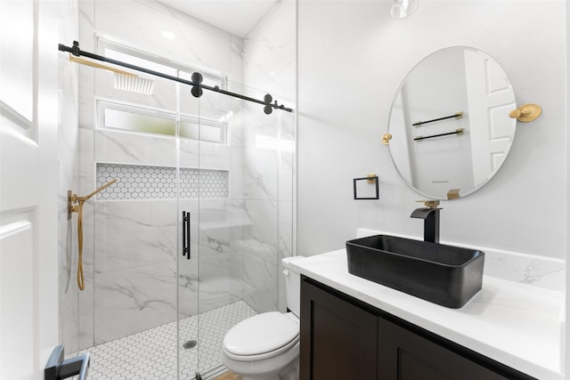 bathroom with vanity, toilet, and a marble finish shower