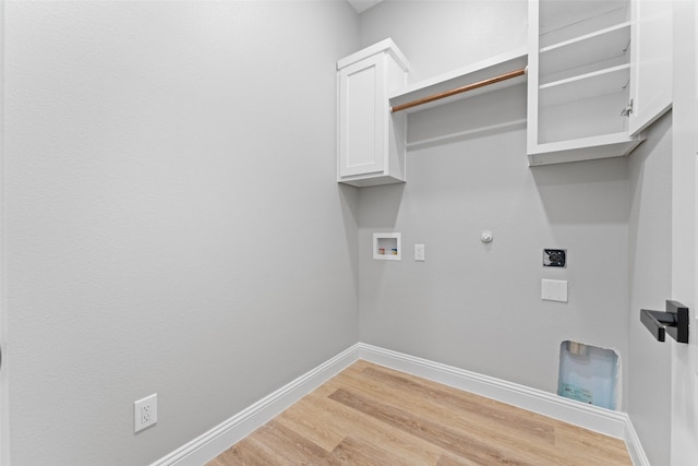 laundry room featuring washer hookup, electric dryer hookup, hookup for a gas dryer, light wood-type flooring, and cabinet space