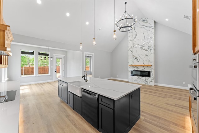 kitchen featuring open floor plan, black dishwasher, high vaulted ceiling, dark cabinetry, and a sink