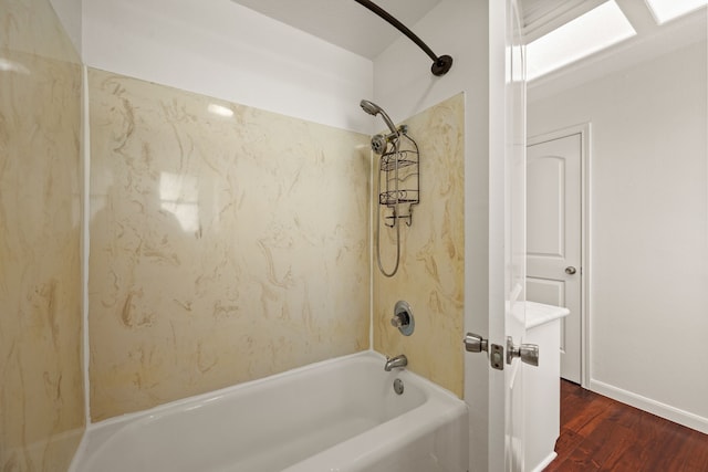 bathroom with wood finished floors and shower / tub combination