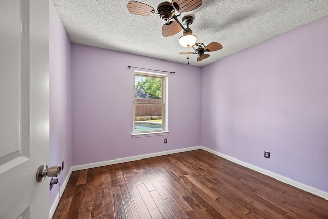unfurnished room with ceiling fan, wood finished floors, a textured ceiling, and baseboards
