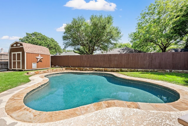 view of swimming pool featuring a storage unit and an outbuilding