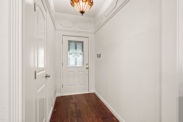 doorway to outside with dark wood-type flooring and baseboards