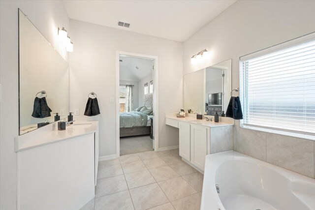 bathroom featuring a shower stall, a garden tub, tile patterned floors, and baseboards