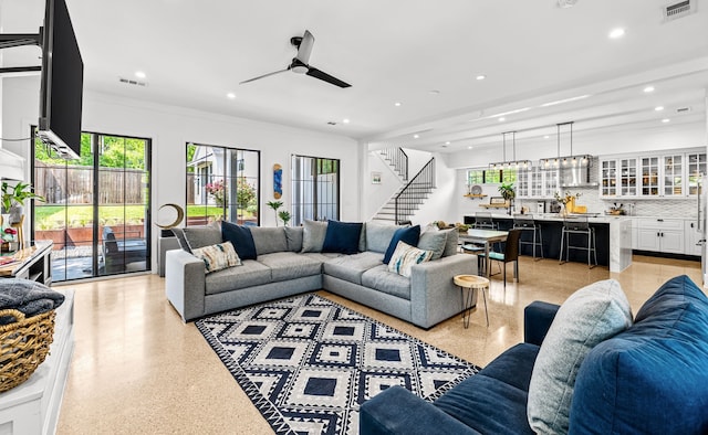 living area with visible vents, recessed lighting, stairs, and light speckled floor