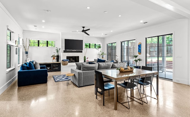 living area with a healthy amount of sunlight, recessed lighting, and a ceiling fan