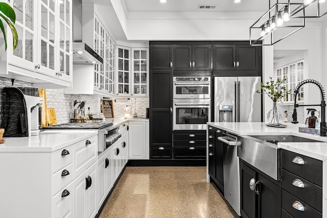 kitchen featuring a sink, dark cabinetry, stainless steel appliances, and visible vents